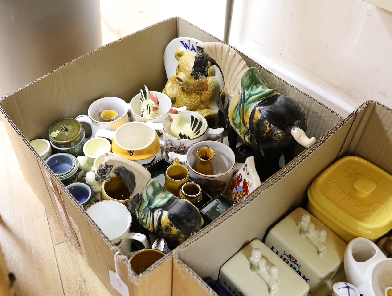 A large quantity of mostly Wade ceramics including some coronation wares, Lurpak butter dishes etc.